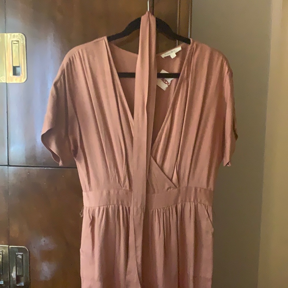Peach colored jump suit. Never been worn!